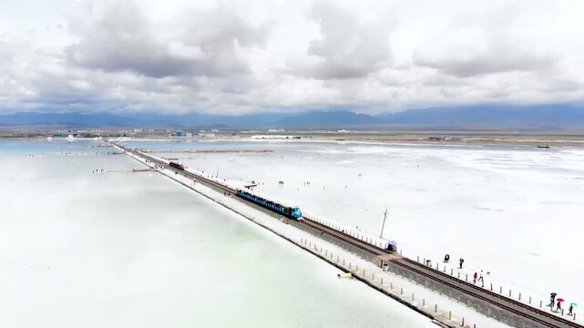 Explore the stunning aerial view of a train traveling over the sky mirror in Xining Qinghai