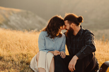 A loving couple enjoys a tender moment together in a beautifully sunlit field, embodying true love and deep connection