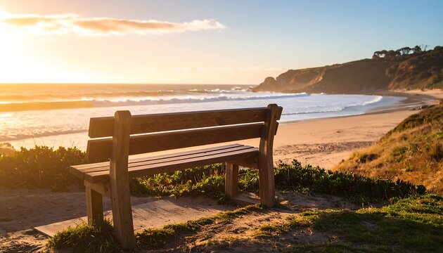 Solitary bench overlooking a tranquil beach at sunset