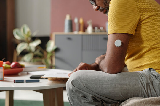 Person with insulin patch using healthcare technology at home