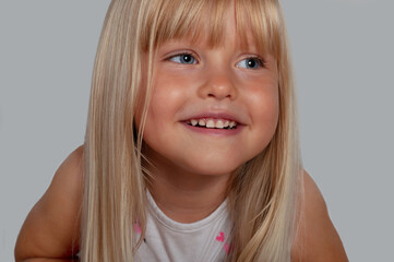 portrait of a happy blond blue-eyed girl 4 years old
