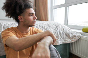 Melancholic african american young man suffering seasonal depression, feeling lonely and having...
