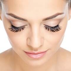 Fototapeta premium Close up of a woman's face featuring dramatic eyelashes and subtle makeup eyes closed isolated on transparent background. PNG die-cut for advertising
