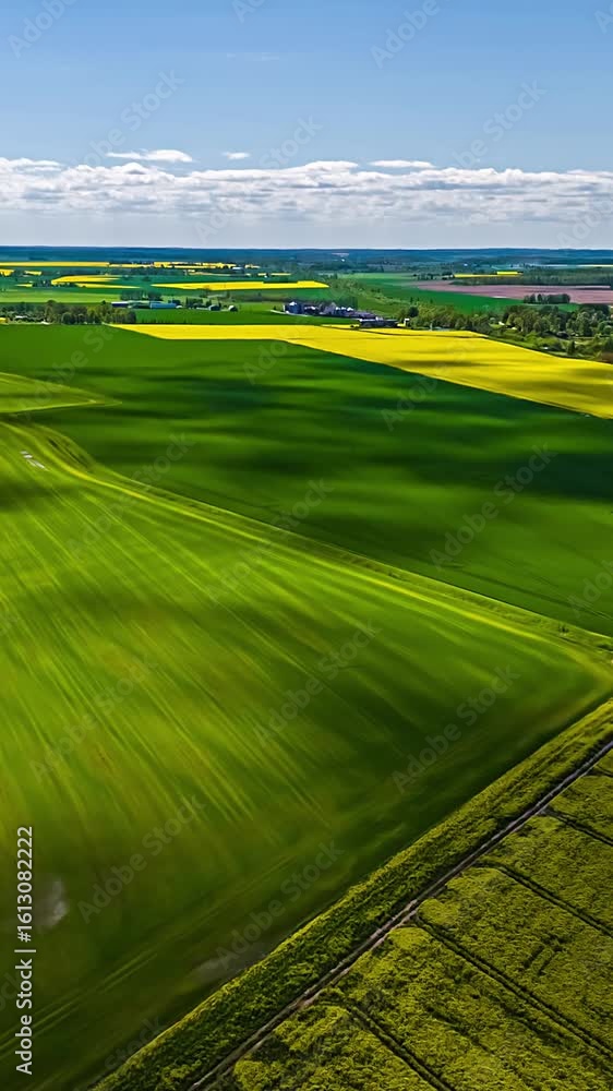 Aufkleber dynamic hyperlapse of green and yellow fields with shadows of clouds drifting across the landscape.