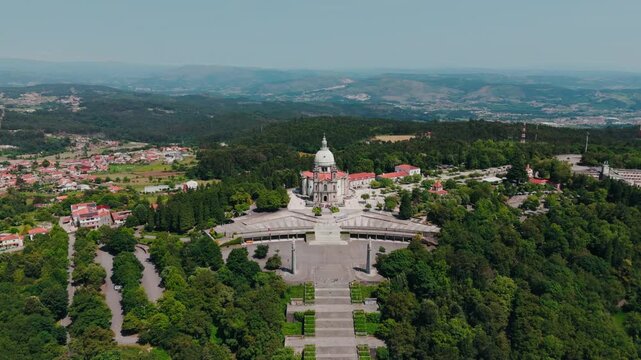 aerial - sanctuary of sameiro in braga portugal surrounded by forest and distant mountains
