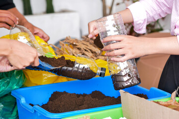 Hands Adding Soil Soil To Plastic Bottle For Repurposing Plastic Waste Into Eco Friendly Plant Pot
