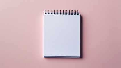 Blank white notepad with black spiral binding in clean flat lay composition. Soft pink backdrop and subtle shadows. Ideal for workspace and productivity visuals