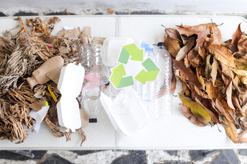 Overhead View Of Recycle Logo Amidst Mixed Plastic Waste And Organic Materials