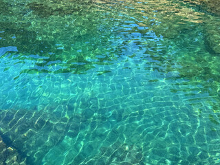 Naklejka premium Emerald green crystal clear sea water surface.