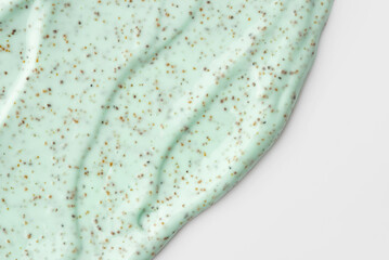 The texture of a mint body scrub with particles. Close-up