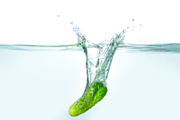 Cucumber Splashing into Clear Water with Bubbles and Ripples