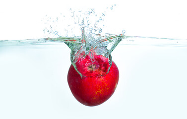 Fresh Red Apple Splashing Into Clear Water With Bubbles