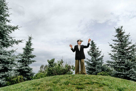 Businesswoman using virtual reality headset outdoors in nature