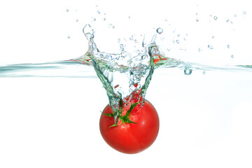 Fresh Red Tomato Splashing Into Clear Water With Bubbles