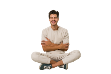 Young caucasian man sitting on the floor isolated on white background who feels confident, crossing arms with determination.