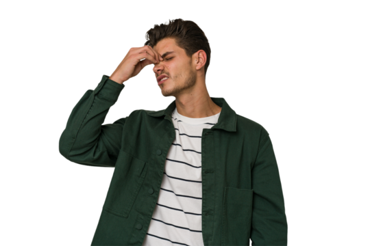 Young handsome caucasian man isolated on white background having a head ache, touching front of the face.