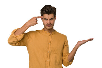 Young handsome caucasian man isolated on white background showing a disappointment gesture with...