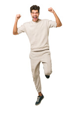 Young caucasian man jumping isolated on white background