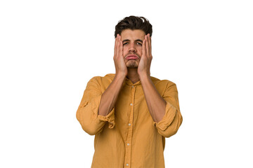 Young handsome caucasian man isolated on white background whining and crying disconsolately.