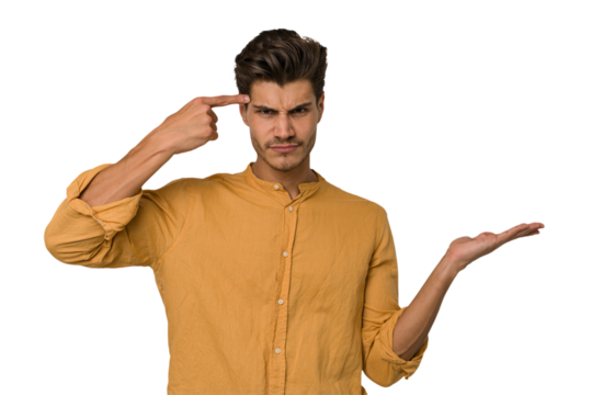 Young handsome caucasian man isolated on white background showing a disappointment gesture with forefinger.