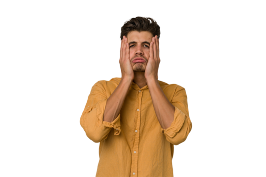 Young handsome caucasian man isolated on white background whining and crying disconsolately.