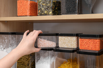 Sorting and organizing dry and loose food supplies in the kitchen, storage