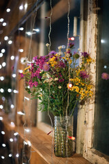 A bouquet of wild flowers on the window