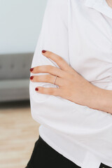 Young woman with a white shirt and a ring  