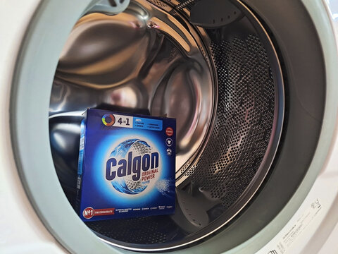 Milan, Italy - September 22, 2024: The Calgon box is located inside the washing machine.