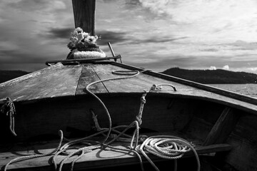 old long-tail boat on the sea in black and white