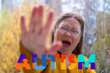 woman reaching out with open hands, rejecting an unseen threat, autism awareness day, personal...