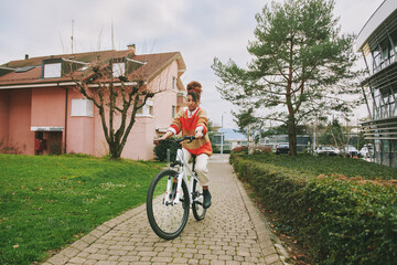 Portrait of african woman riding bike outdoors