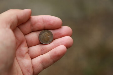 Hand holding few small Dutch coin