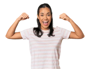 Fotobehang Young Filipina woman showing strength gesture with arms, symbol of feminine power © Asier