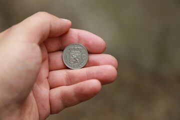 Hand holding few small Dutch coin
