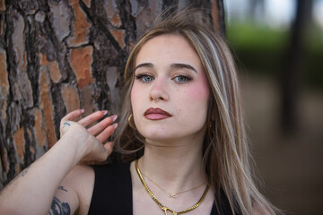 Portrait of a young, beautiful woman, blonde, with green eyes, wearing a black top, looking sweetly...
