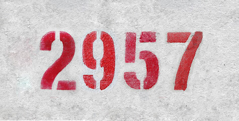 red spray-painted number 2957 sprayed onto a white wall.