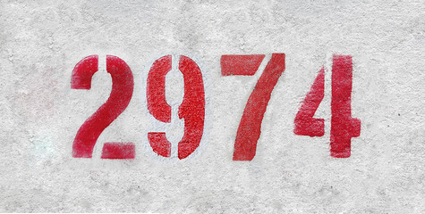 number 2974 . Red spray paint the white wall
