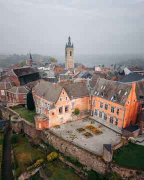 Aerial view of old brick buildings and a stone tower rise amidst a historic town, capturing the essence of European heritage, Thuin, Wallonia, Belgium.