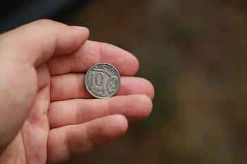 Australian change coin in hand