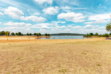 Swimming lake at Ramsberg Harbor. Lake Big Brombach (Großer Brombachsee) and blue sky with clouds. Pleinfeld, Germany. Water Reservoir in the south of Middle Franconia