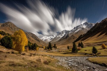 Mountain valley at night, with autumn colors and star trails