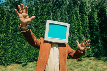 Person with retro monitor head outdoors showing surprised expression