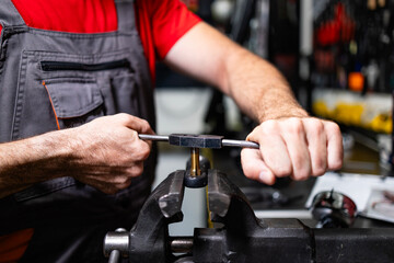 Close up view of mechanic hands working with metal.