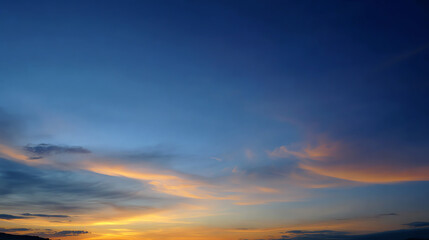 Obraz premium A breathtaking sunset sky painted in shades of blue and orange, showcasing the beauty of nature's evening palette.