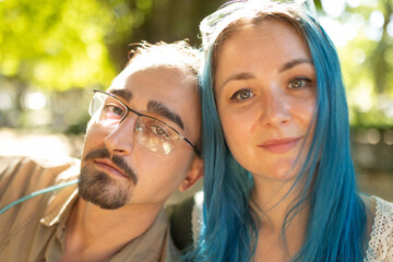 Young couple posing together outdoors in a park