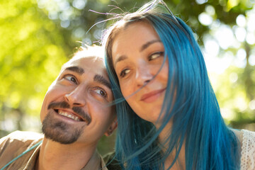 Young couple smiling and leaning heads together outdoors