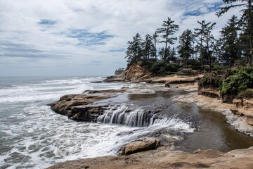 Pacific coastline with a small waterfall cascading over rocks