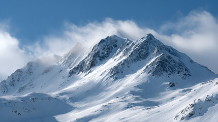Stunning snow-capped peaks rise majestically against a clear blue sky, creating a breathtaking winter landscape.