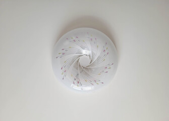 Round glass white chandelier on the ceiling